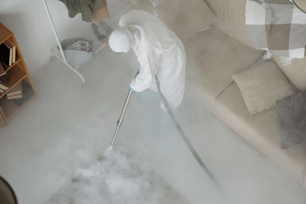 Biohazard cleanup technician in protective equipment, Hamlin, TX